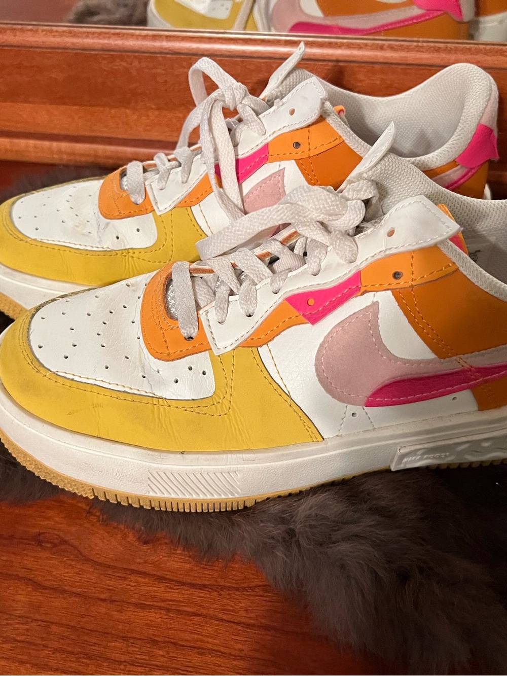 Nike women’s Low-Top Sneakers in White with Yellow, Orange & Pink Accents